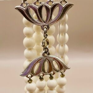 4 rows of White beads and silver Floral closure Bracelet . Elegant. Classic.